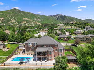 View of pool with a mountain view and a patio area