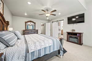 Primary Bedroom featuring a barn door, recessed lighting, baseboards, light carpet, and a ceiling fan