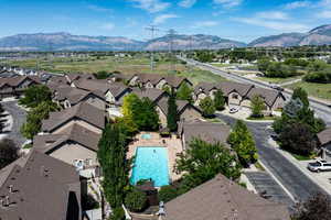 Aerial perspective of suburban area featuring a mountainous background and a pool area