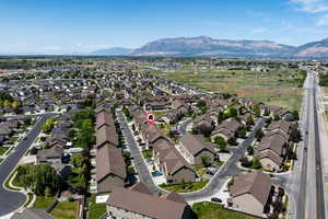 Aerial overview of property's location featuring nearby suburban area and mountains