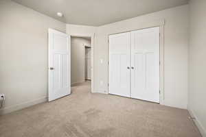 Bedroom 3 with carpet floors, baseboards, and a closet