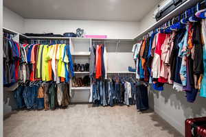 Primary Walk in closet featuring carpet floors