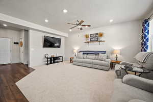 Living room featuring recessed lighting, a ceiling fan, a textured ceiling, baseboards, and wood finished floors