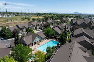 Aerial view of residential area with a pool area and a mountain backdrop