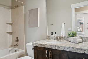 Full bath with shower / tub combination, vanity, and toilet