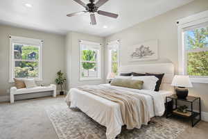 Carpeted bedroom featuring baseboards, recessed lighting, and ceiling fan