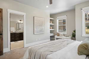 Bedroom featuring light colored carpet, baseboards, ensuite bathroom, ceiling fan, and recessed lighting