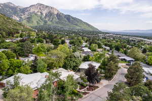 Aerial view of property's location featuring a mountainous background and nearby suburban area