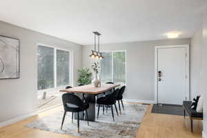 Dining room with light wood-style flooring and baseboards