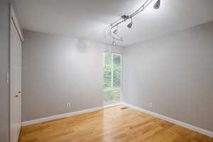 Empty room with wood finished floors and baseboards