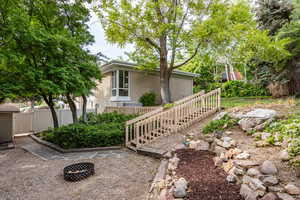 View of home's exterior featuring brick siding and a fire pit