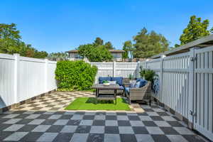 Fenced backyard featuring an outdoor hangout area and a patio area