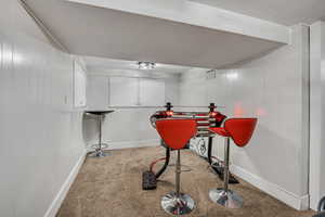 Workout area featuring carpet and baseboards