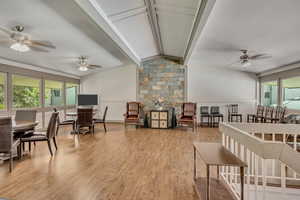 Dining space featuring a ceiling fan, beam ceiling, and light wood-type flooring