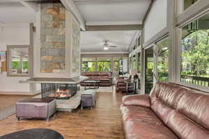 Living area with wood finished floors and ceiling fan