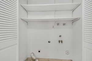 Laundry area featuring gas dryer hookup, hookup for an electric dryer, washer hookup, and tile patterned flooring