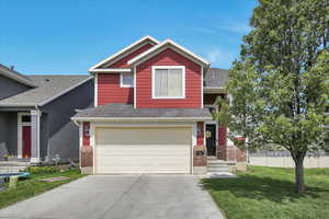 View of front of home featuring driveway, a garage, brick siding, and a shingled roof