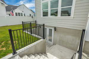 View of patio with a balcony