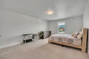 Carpeted bedroom featuring baseboards