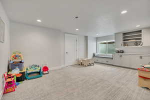 Rec room featuring recessed lighting, light carpet, and baseboards