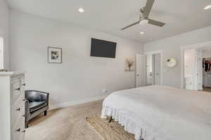 Bedroom featuring light colored carpet, recessed lighting, baseboards, and a ceiling fan