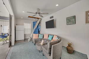 Living area featuring a ceiling fan, recessed lighting, and concrete floors