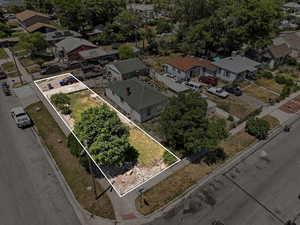 Aerial overview of property's location featuring nearby suburban area and property parcel outlined
