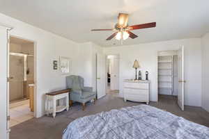 Bedroom with carpet, ensuite bath, and ceiling fan
