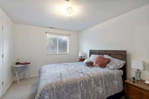 Carpeted bedroom with baseboards and a textured ceiling