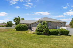 View of side of home featuring brick siding and roof with shingles