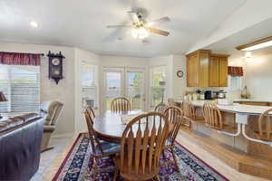 Dining room featuring a ceiling fan, healthy amount of natural light, a textured ceiling, baseboards, and recessed lighting