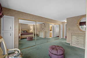 Carpeted bedroom featuring a textured ceiling