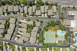 View of property location with a pool area and nearby suburban area