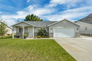 Ranch-style house with stucco siding, driveway, an attached garage, stone siding, and roof with shingles