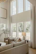 Living room featuring healthy amount of natural light and a high ceiling