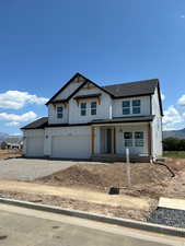 Modern farmhouse featuring an attached garage, a porch, dirt driveway, board and batten siding, and roof with shingles