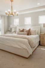 Bedroom featuring a chandelier and multiple windows