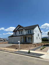Modern farmhouse style home with gravel driveway, covered porch, a garage, board and batten siding, and a shingled roof