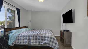 Bedroom with multiple windows, carpet floors, and baseboards