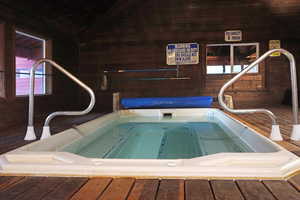 View of swimming pool featuring an indoor hot tub