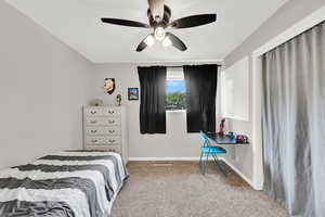 Bedroom with carpet flooring, baseboards, and a ceiling fan