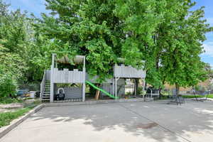 View of community featuring a playground and stairway