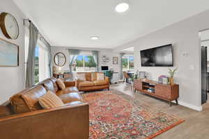 Living room featuring light wood-style flooring and baseboards