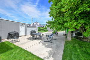 View of patio featuring grilling area, central air condition unit, and outdoor dining space
