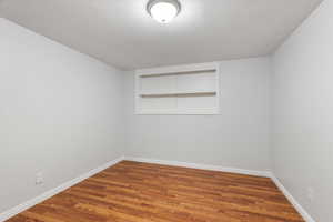 Spare room with wood finished floors and baseboards