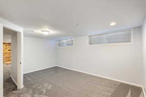 Finished basement featuring carpet flooring, baseboards, and recessed lighting