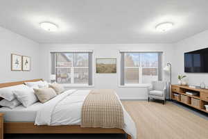 Bedroom featuring multiple windows and baseboards