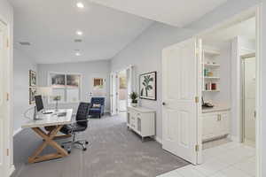 Office featuring recessed lighting, baseboards, vaulted ceiling, and light carpet