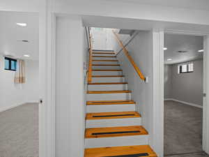 Stairway with carpet, recessed lighting, and baseboards
