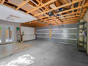 Garage featuring french doors and a garage door opener